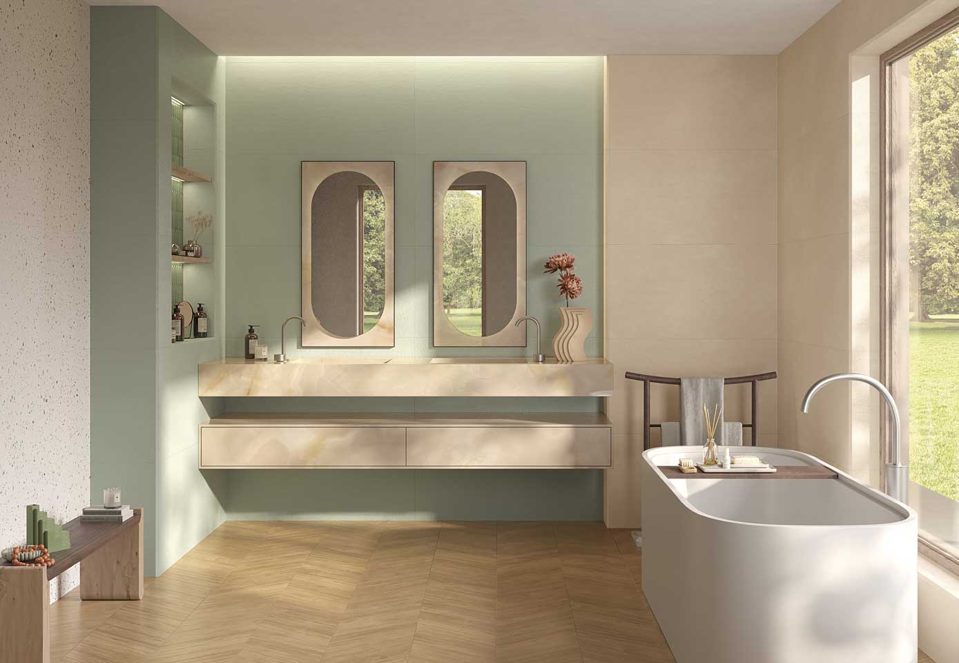 Elegant bathroom with green and beige ceramic walls, onyx effect top, freestanding bathtub and wood-effect stoneware floor plug, double oval mirror.