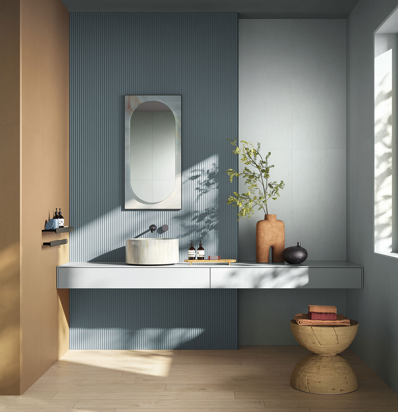 Modern bathroom with opaque ceramic wall tiles, light blue fluted wall, marble sink and terracotta decorative fixtures, wood effect flooring, oval speecchio.