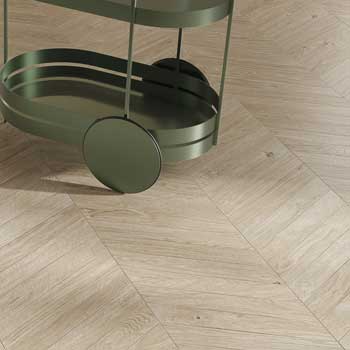 Light wood effect ceramic floor detail with plug-in laying and matte green trolley with contemporary design.