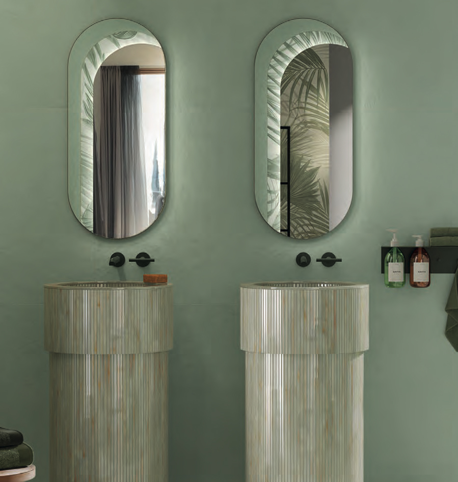 Oblò mirrors with Tropical decoration on a mint green wall, Gemme Menta striped washbasin, coloured dispensers and matt black taps.