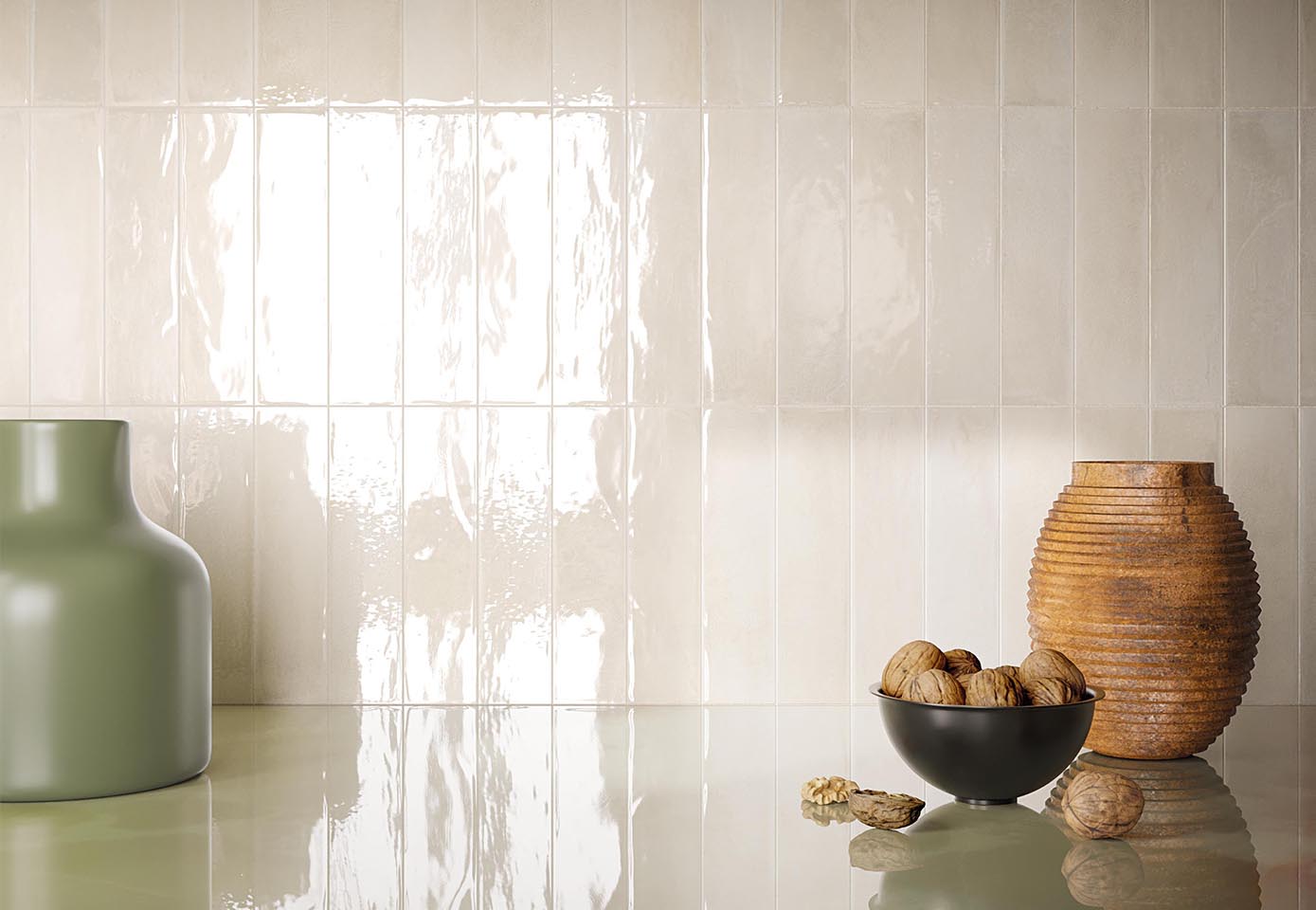 Glossy beige brick-effect ceramic wall tiles, green and gold textured vases, and reflective top in matching colour.