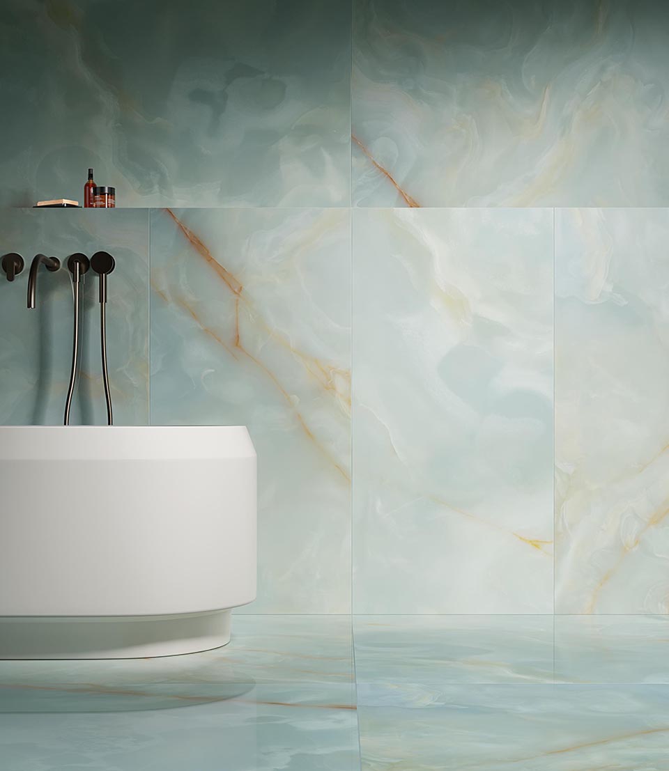 Polished onyx-effect light blue stoneware wall tiles with orange veins, combined with modern bathtub and matt black wall fittings.
