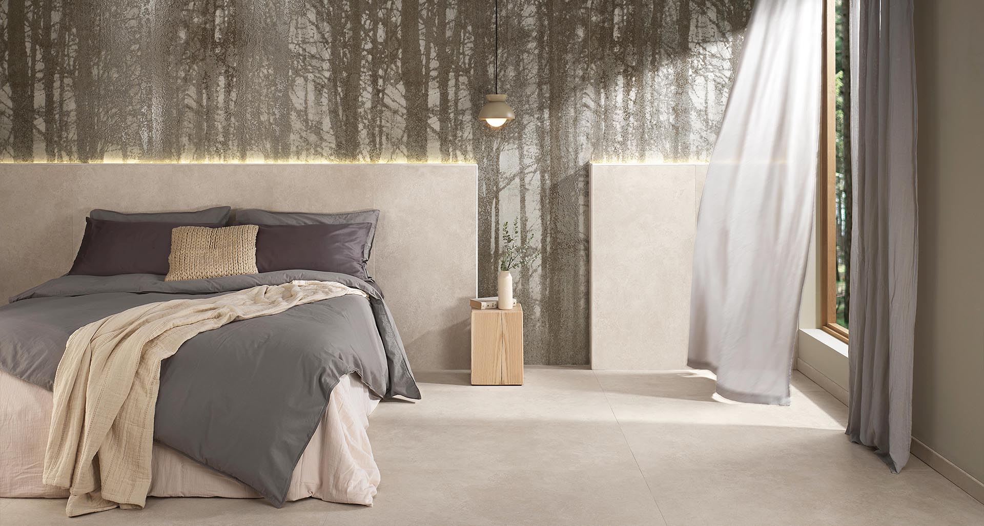 Bedroom with headboard and floor in beige stone-effect stoneware and large wood-effect slab covering, double bed, hanging lamp.