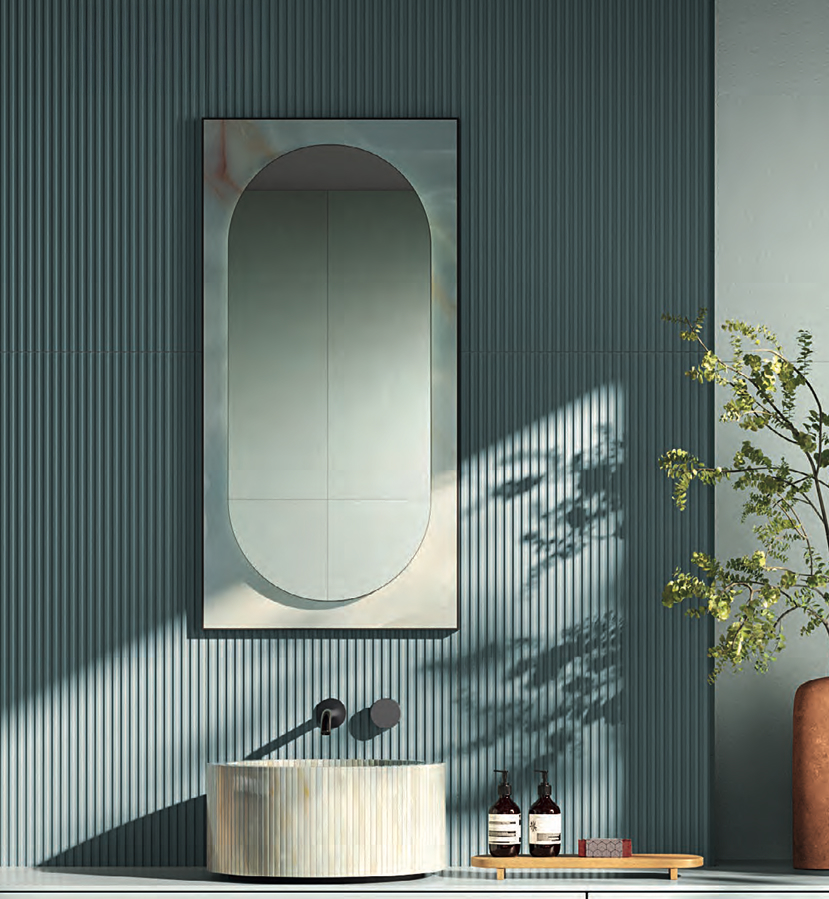 Portale mirror with Gemme Cielo ceramic border on striped wall covering; striped washbasin, beauty elements and decorative plant.