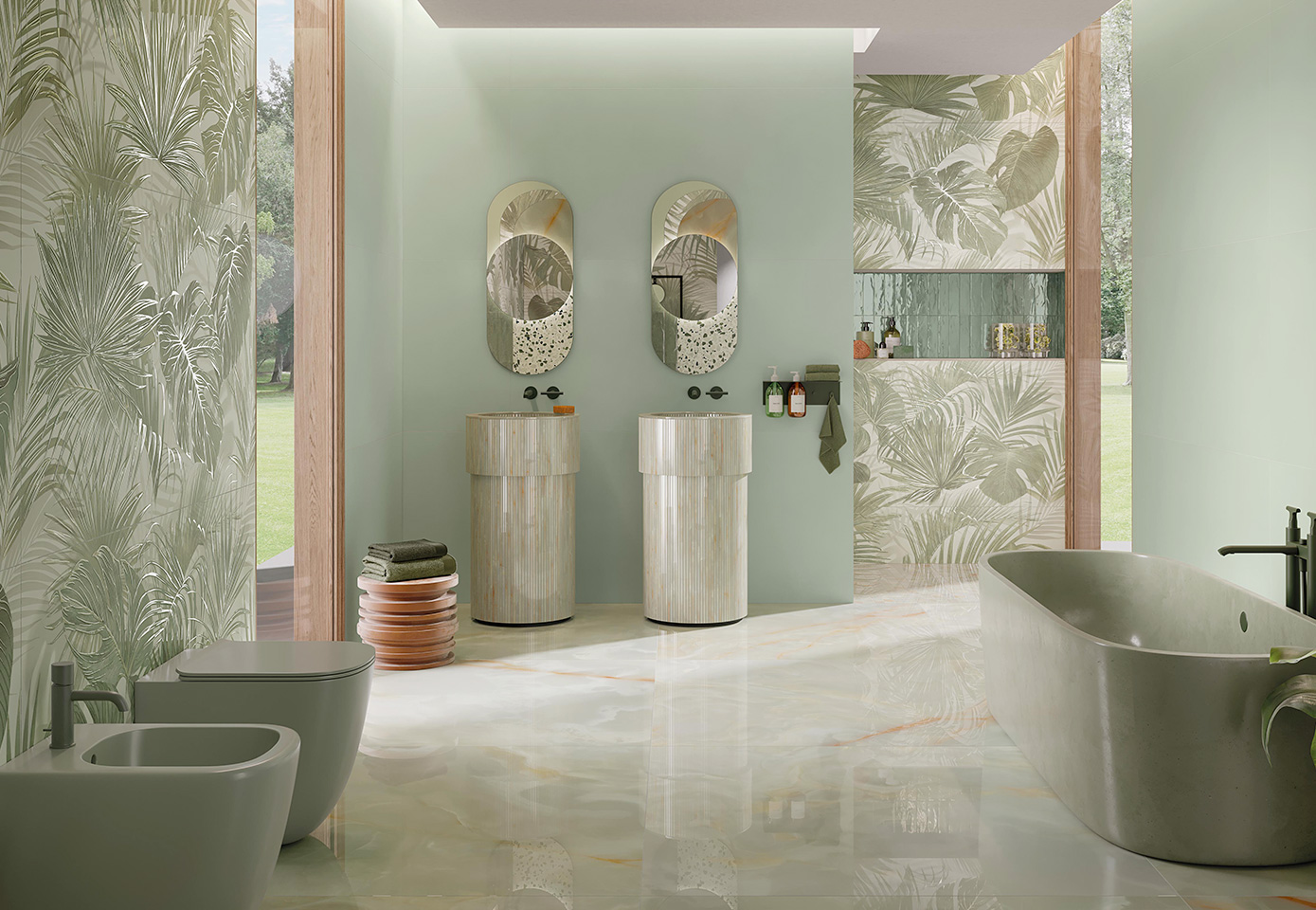Modern bathroom with sage green wall tiles, striped onyx washbasin, double oval mirror, decorated jungle wall and marble-effect flooring.