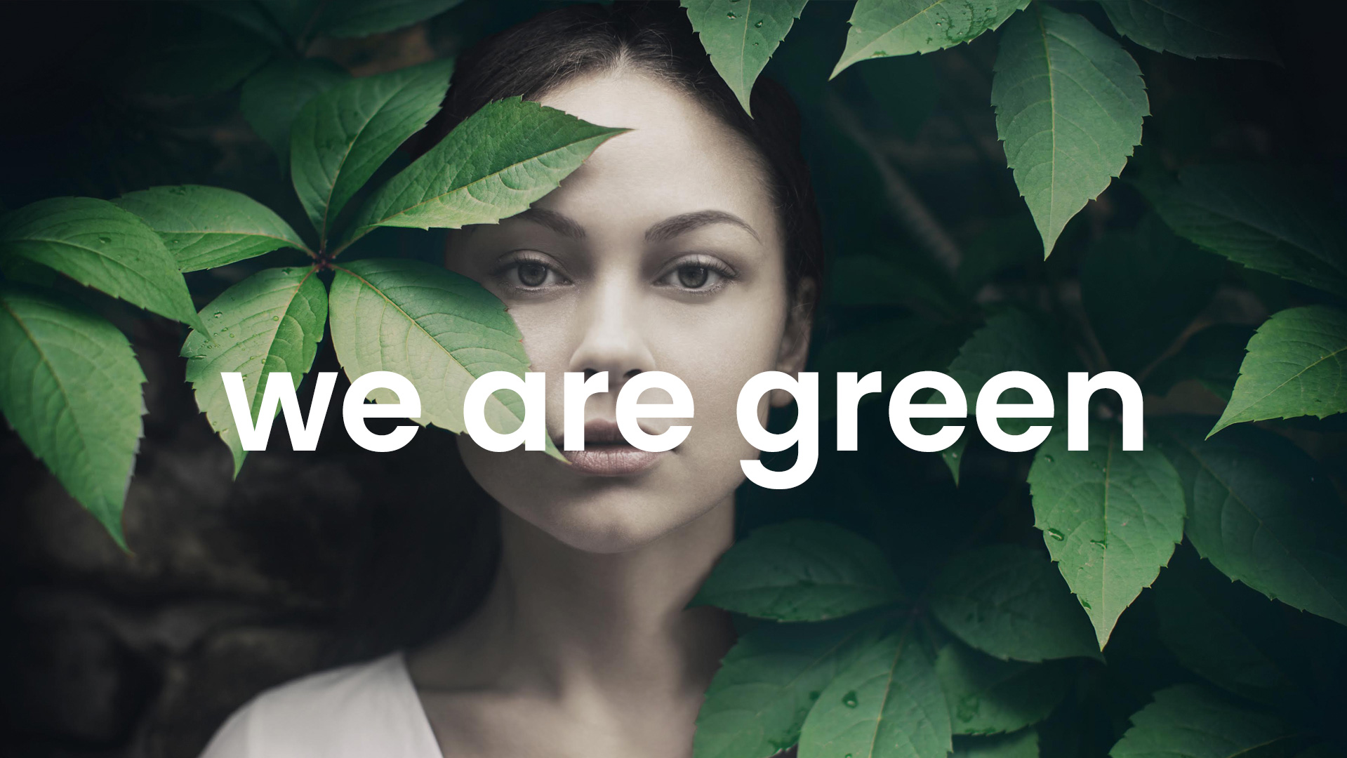 Female portrait surrounded by green leaves, a visual symbol of environmental commitment with “we are green” written in the foreground.
