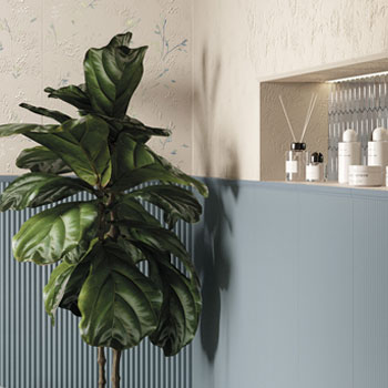 Textural beige wall with light blue ceramic boiserie and decorative niche, furniture plan and bathroom products.