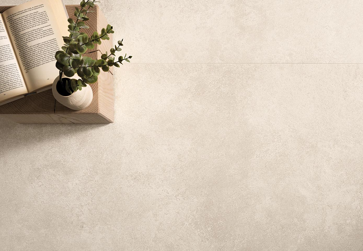 Light beige stone-effect porcelain stoneware floor, with wooden support and decorative vase.