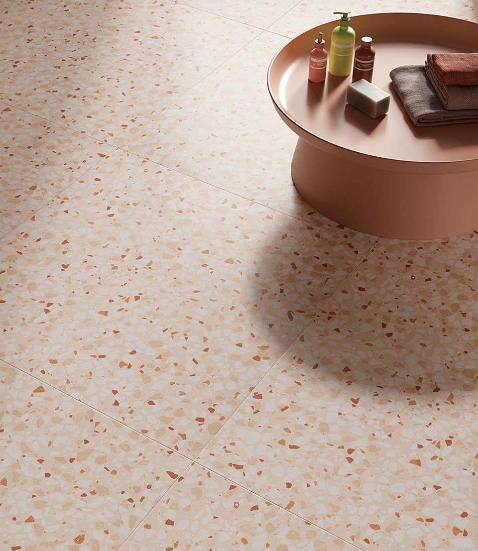 Powder pink terrazzo effect floor with powder pink coffee table and beauty accessories.