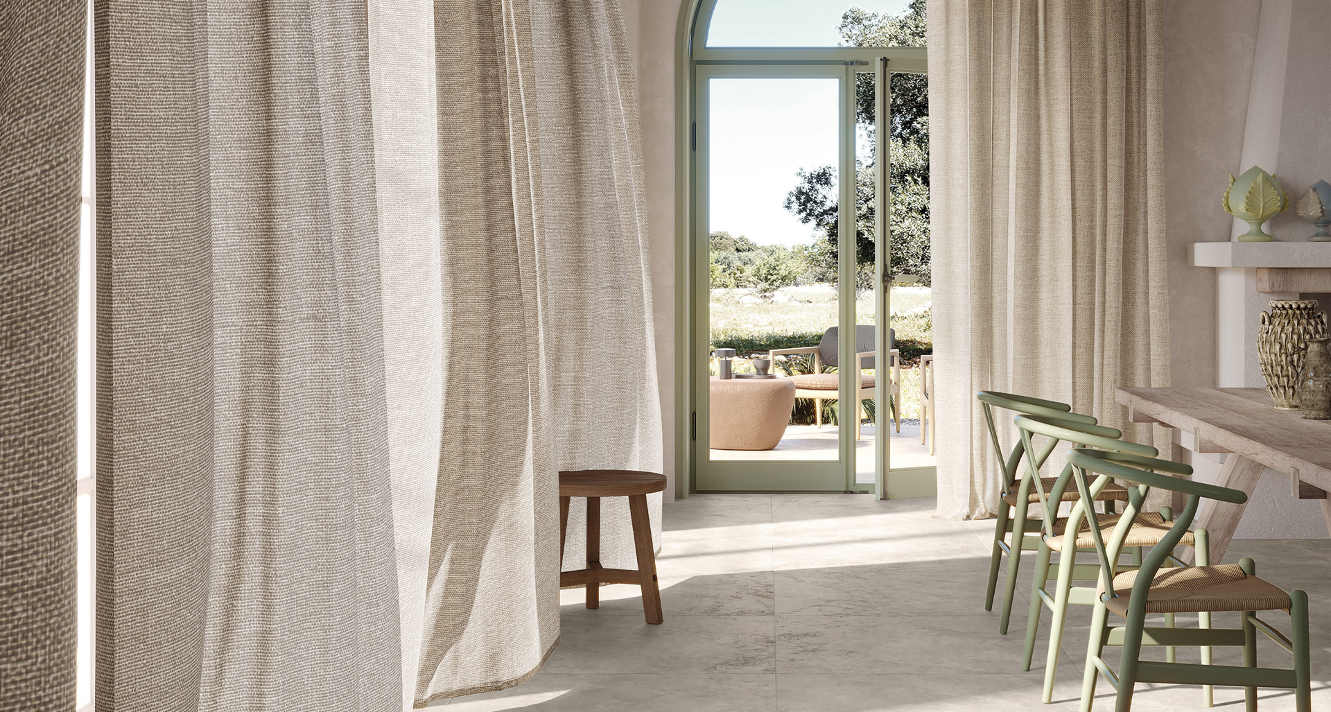 Light stone effect floor, natural wood table with sage green rustic chairs, raw fabric curtains.