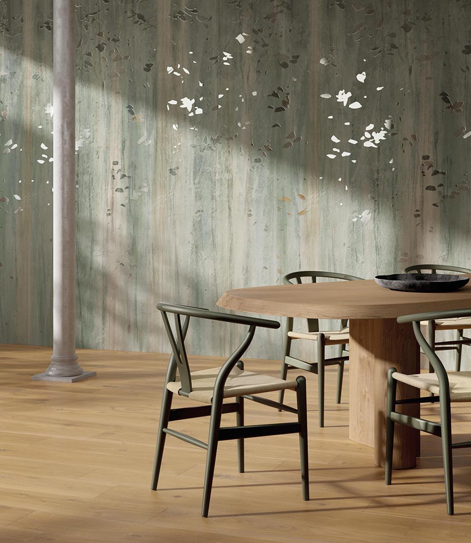 Textured decorative wall with green-grey watercolour effect and glossy inserts simulating petals on a textured background.