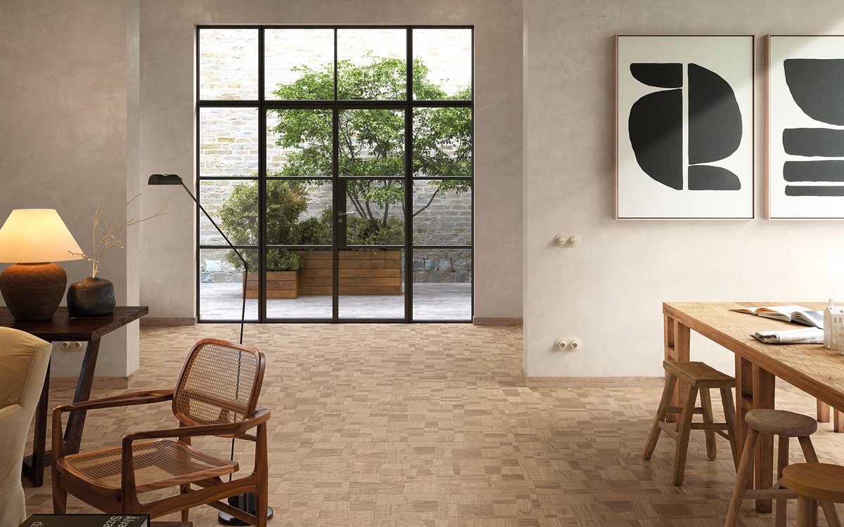 Natural living room with greige walls, light wood-effect flooring, and large black iron windows opening onto the garden.