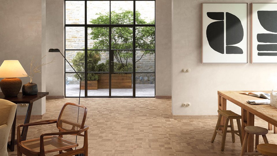 Natural living room with greige walls, light wood-effect flooring, and large black iron windows opening onto the garden.