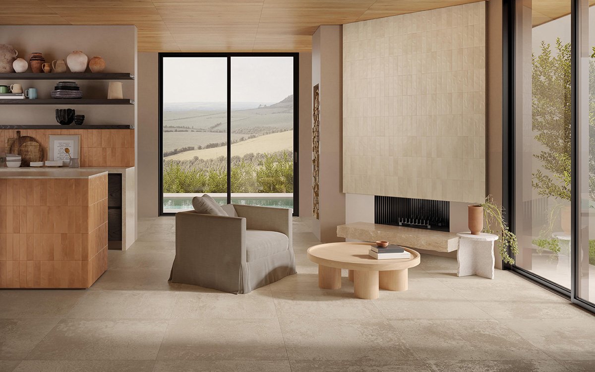 Bright living area with beige stone-effect flooring, light ceramic wall cladding and terracotta-coloured kitchen.